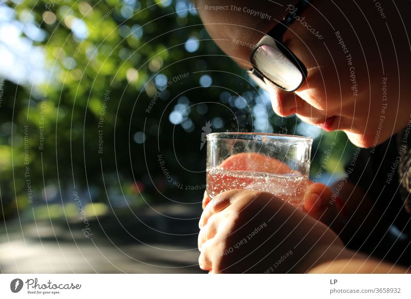 boy observing sparkling water in a glass Observe observer Looking Watchfulness curious Curiosity Light Water Zen holding mindfulness Human being