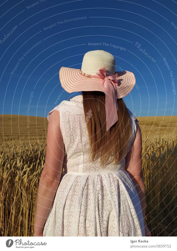 Rear View Of Woman In Field Against Sky woman Farm Hat Crops Blue Sunlight Rear view Portrait photograph Fashion white dress Rural Scene Agriculture