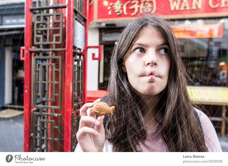 girl funny fish face in Chinatown - a Royalty Free Stock Photo
