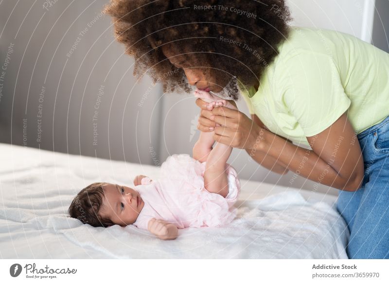 Content ethnic mother playing with baby infant woman tender newborn adorable content having fun home female african american black cheerful parent kid child