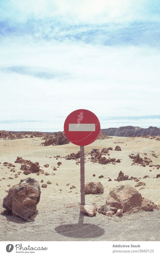 No entry road sign on dry desert road no entry prohibit one way rectangle regulation caution restriction stop signboard notice warning round red daytime terrain