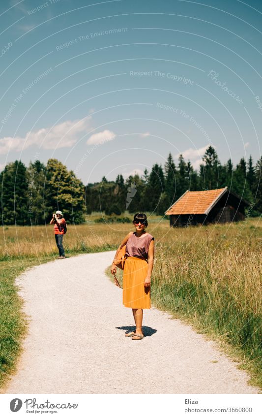 A young woman walking in the country in summer To go for a walk Trip Summer Woman rural Nature Family outing Landscape Relaxation Vacation & Travel Hiking
