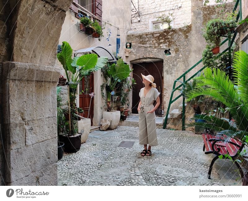 Female tourist sightseeing in traditional medieval costal town, Trogir, Croatia. Woman Sightseeing Old Town Old town Exterior shot Architecture Historic