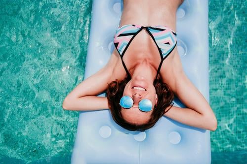happy woman on inflatable having fun. Summer time. top view swimming pool summer blue water relax hat sexy lifestyle sunglasses swimwear hot body tanning spa