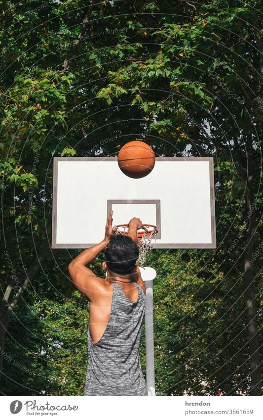 young man in front of the basket throwing the ball sport basketball competition game athletic competitive play playing exercise male exercising effort hobby
