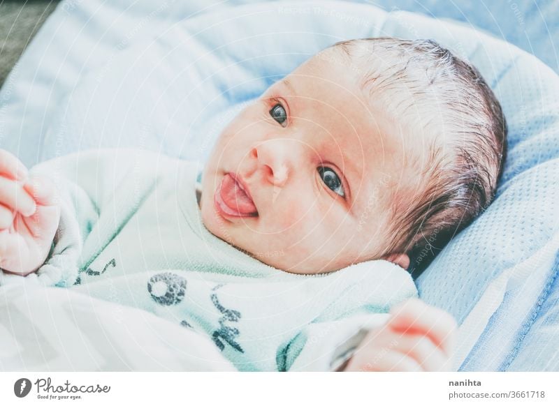 Lovely newoborn caucasian girl baby face cute new born newborn child birth first month boy family daughter son lovely adorable real tired sleep calm quiet lying