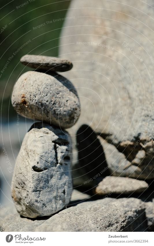 Small stone man, stacked stones in close-up Cairn Pebble Meditation Sun detail attentiveness Relaxation tranquillity Harmonious Serene Contentment Close-up
