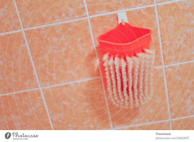Wash glove with bristles at rest Bathroom bathroom bathroom tiles Bristles Personal hygiene Healthy Clean bursts Red White Pink Tile joints Checkmark Hang up