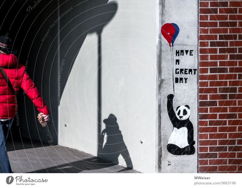 The Panda with the balloon wishes you a nice day Balloon Graffiti Wall (building) Human being Shadow Red Hat Breakfast Tunnel Entrance brick Wall (barrier) Town