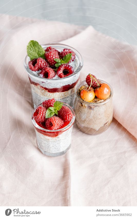 Glass jars with puddings with chia seeds and assorted berries breakfast healthy food raspberry jam cherry glass sweet super food delicious weight loss natural