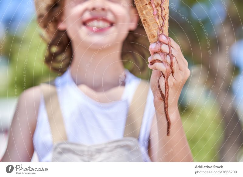 Delighted boy with tasty ice cream cone melt pleasure glad weekend vacation summertime dessert nature treat child smile delicious food yummy childhood street