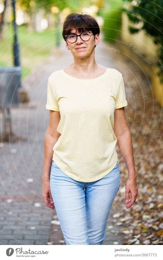 Beautiful Middle-aged woman walking down the street female 50s outdoor mockup cute lifestyle casual caucasian single sitting beautiful leisure person eyeglasses