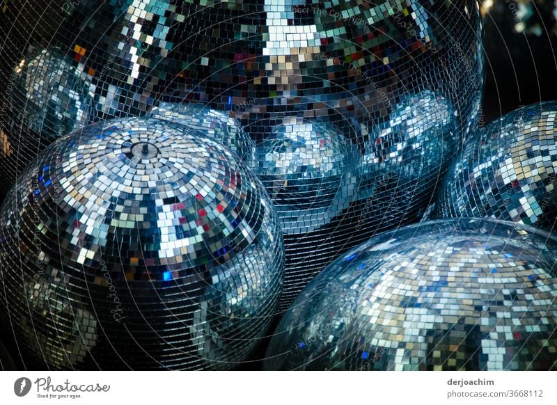 Disco bullets... 1. a lot of shiny disco balls next to each other on earth. Disco balls Light Leisure and hobbies Party Club Dance Feasts & Celebrations Music