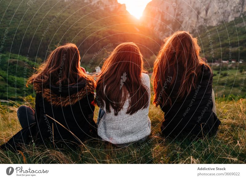 Anonymous smiling women on lawn in highlands friend mountain sunset chill together unity friendship girlfriend transylvania romania saint george picturesque