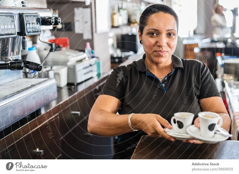 Ethnic female barista with coffee in bar woman service staff occupation serve small business waitress employee drink job coffee shop confident espresso ethnic