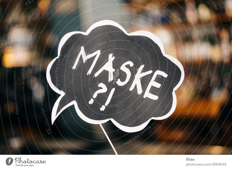 A sign with the inscription "Mask?!" as a reminder to guests to observe the obligation to wear a mask. Catering. Corona. Mask obligation question Gastronomy
