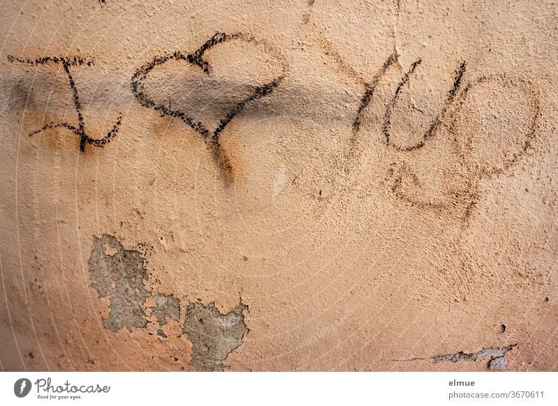 Love has upset the oh-so-cool teenager...  ...but he was correcting his scribbles... "I love you" is now written on the house wall. i love you writing