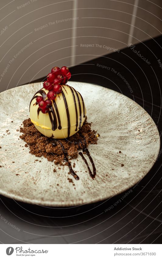 Yummy dessert with fresh cranberries cranberry plate chocolate sauce topping sweet restaurant ball dish confectionery meal portion cafe yummy nutrition tasty