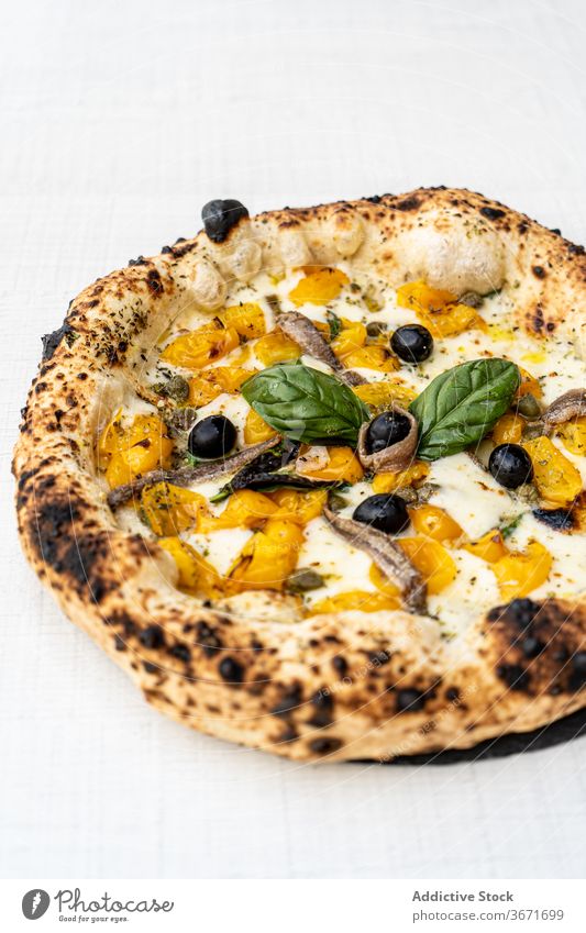 Delicious cheese pizza with yellow tomatoes and olives basil crust delicious italian food traditional gourmet dish tasty meal delectable palatable yummy