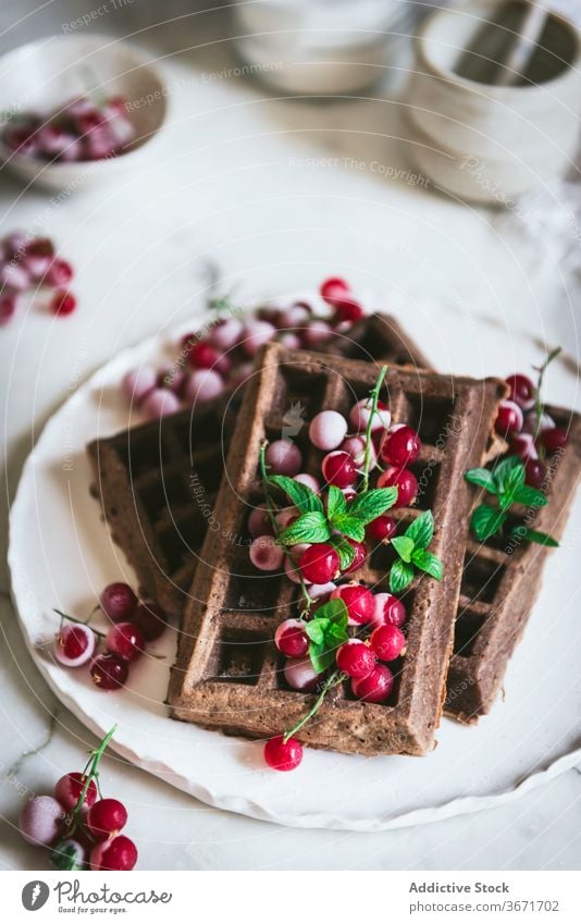 Oatmeal chocolate waffles with gooseberries oatmeal kitchen culinary vertical timber homemade bake food pastry table detail food composition natural dish style