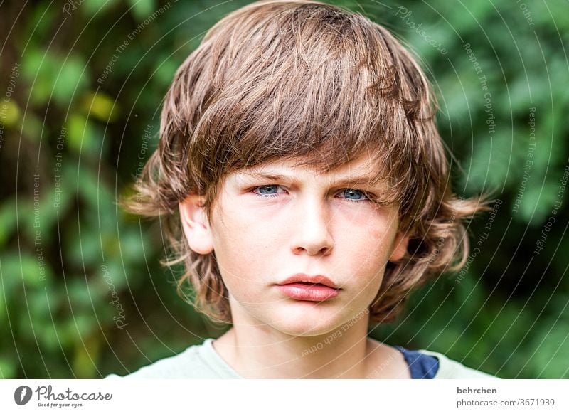 Mat Cool (slang) Brash long hairs Colour photo Family Close-up portrait Contrast Light Day Face Infancy Boy (child) Child Sunlight Hair and hairstyles Mouth