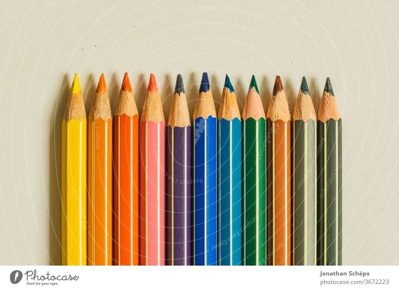 coloured pencils in all colours on white background made of paper graphic crayons First day at school first school day surface Free space Elementary school