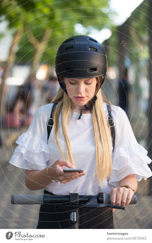 Woman using smartphone and renting modern electric scooter with an application. Urban transport concept bike city girl future lifestyle street transportation
