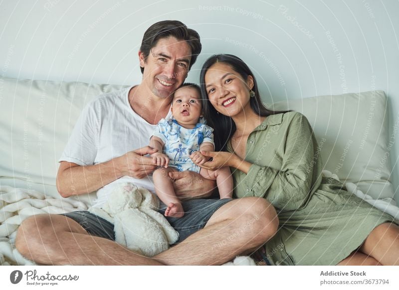 Parents sitting with their son enjoying the time together at home family baby child boy dad father mom mother fun stay at home beautiful model portrait flat