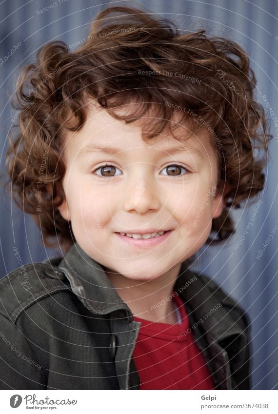 Beautiful boy with nice eyes adorable background beautiful beauty casual caucasian cheerful child childhood children curly cute educate expressing expression