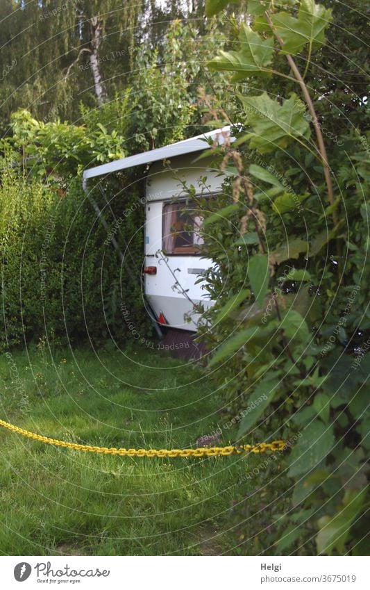 no access - caravan is between hedges, the area is locked with a yellow chain Caravan Camping Camping site Hedge Plant bushes Chain Meadow Grass