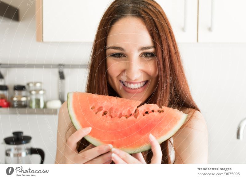 Woman eating watermelon kitchen healthy woman food young fruit beautiful fresh home female lifestyle happy diet girl caucasian nutrition pretty vegetarian
