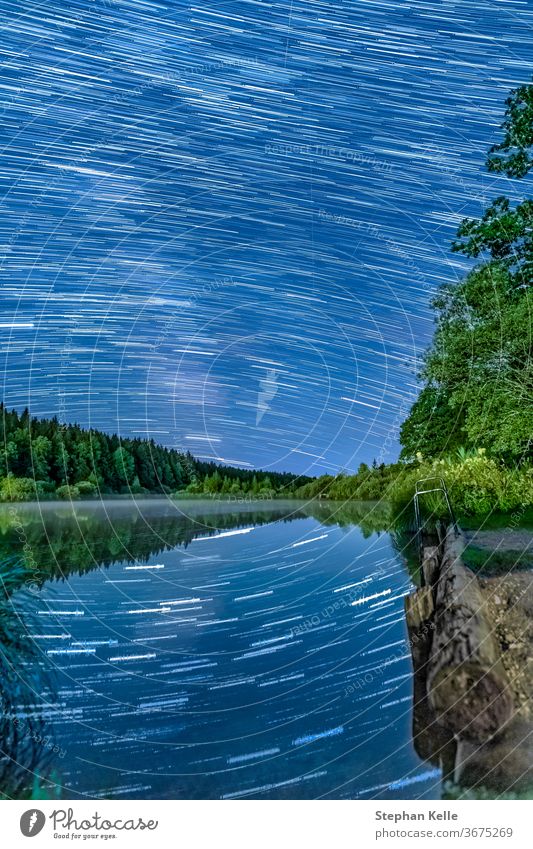 Long Exposure Startrails over an idyllic lake with star reflections in the water - wonderful star clear night. startrails exposure long landscape nature