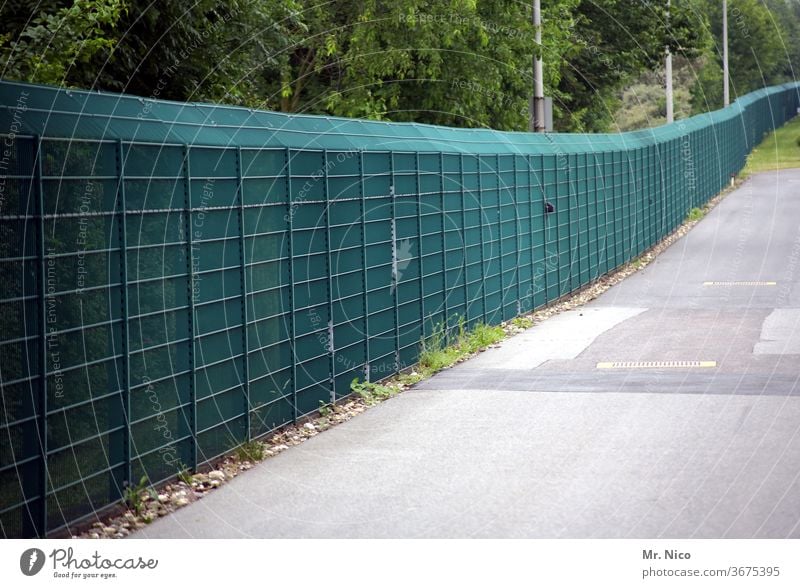 A long green fence Barrier Safety Fence cordon Captured Threat Border Freedom Protection Escape exclusion captivity Bans penned refugee camp No admittance