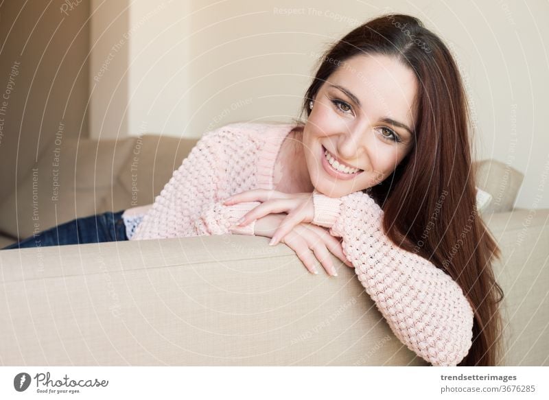Woman portrait woman sofa home happy room couch relax living beautiful young people sitting person female white adult house one girl caucasian lifestyle leisure