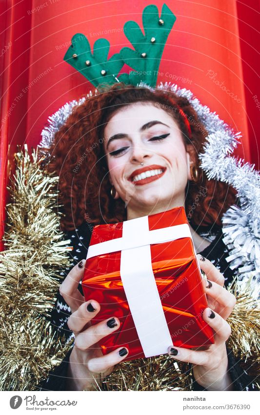 Beautiful redhead young woman with christmas stuff holidays gift people real pretty youth happy happiness merry christmas decor decoration hairband horns