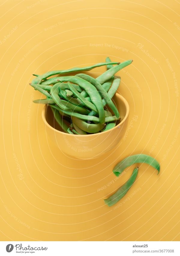 Green beans in a bowl on yellow background with copy space agriculture cuisine diet food fresh freshness green green bean group healthy ingredient legume long