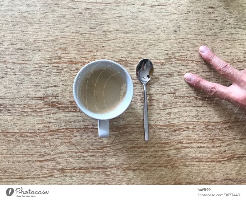 two fingers of coffee with spoon Coffee To have a coffee Coffee cup Table Fingers by hand Cup Beverage Hot drink Drinking Coffee break Espresso Café
