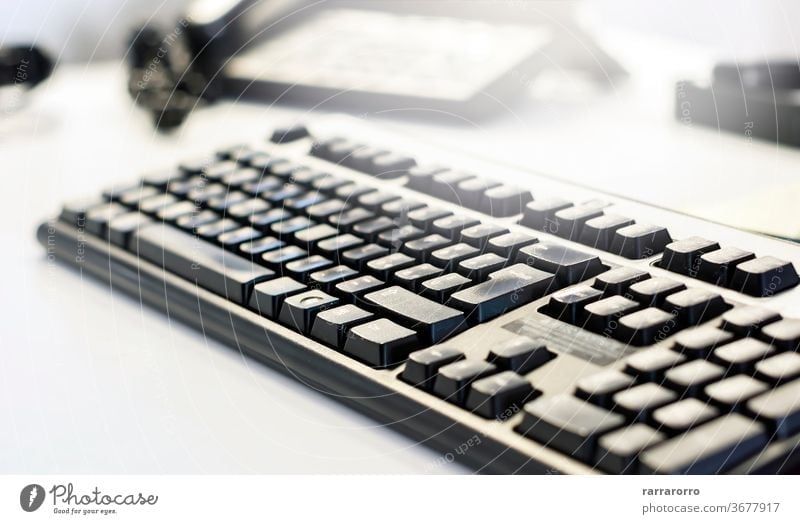 a black computer keyboard on an office table. technology background business button internet closeup communication work electronic pc white object modern