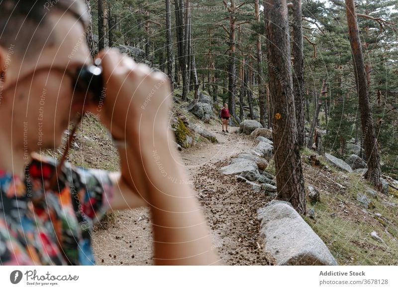 Traveler exploring nature with binoculars in forest man hike mountain explore travel activity trekking young discovery adventure spain navacerrada madrid male
