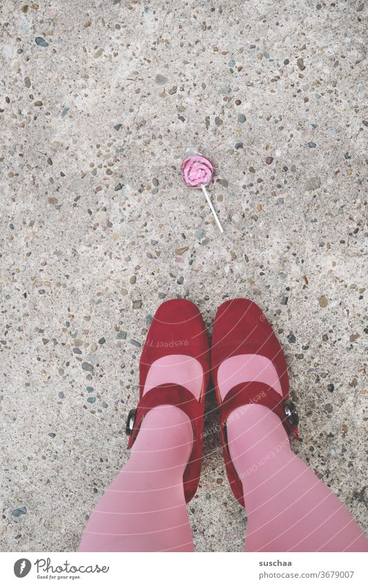 a lollipop on the street with lady's feet Woman Feminine feminine Footwear High heels Ladies' Feet Stockings Street Asphalt Legs Whimsical Pink Red candy Sugar