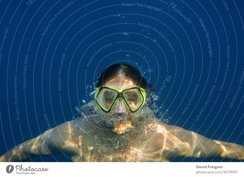 Male diver in blue water. Open sea, ocean, swimming, active travel and underwater diving concept. free mask man sport young people male nature silence air abyss