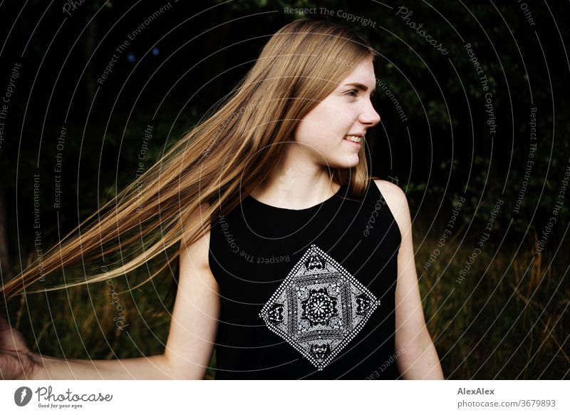 Lateral portrait of a young woman in nature in front of a forest, spreading her hair Purity luck Beautiful weather Trip Expectation Sunlight Close-up Day
