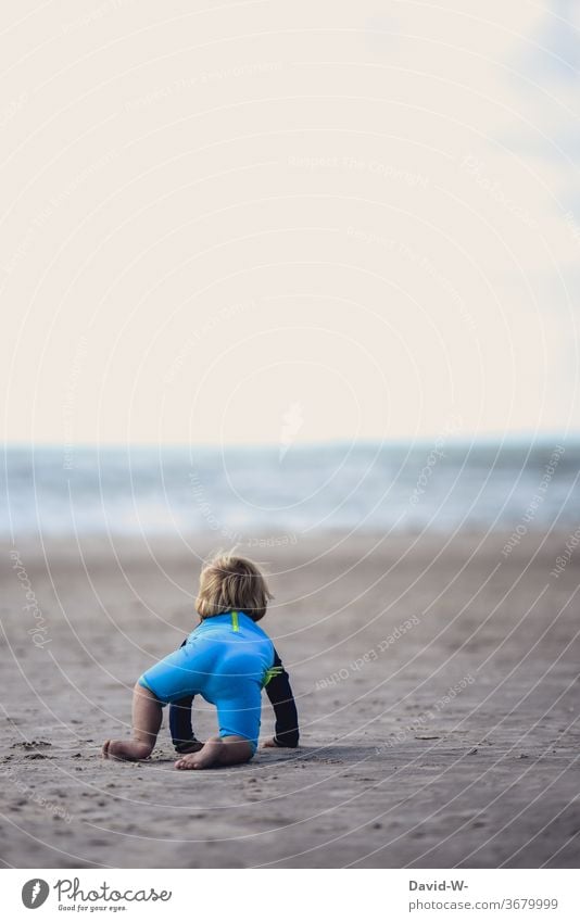 little boy feels magically attracted to the sea Child Boy (child) Toddler look at contemplating impressed Ocean ocean Waves vacation Beach by oneself Think