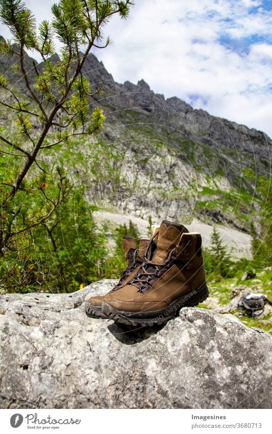 Hiking boots, which are on a stone. grey boots high in the mountains a few Stone rock Boots garments Footwear Summer Sky Couple Nature Rock - Object Adventure