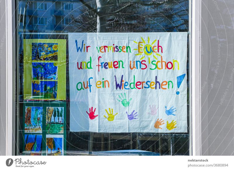We Miss You and Hope to See You Soon Children's Sign in German We miss you sign colorful glass window handprint hands arts and crafts no people nobody painting