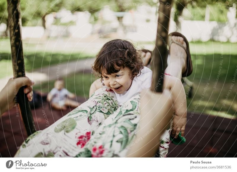 Mother playing with daughter on swing Swing Playground Caucasian Playing Joy Movement To swing Park Child Leisure and hobbies Smiling Human being Happiness