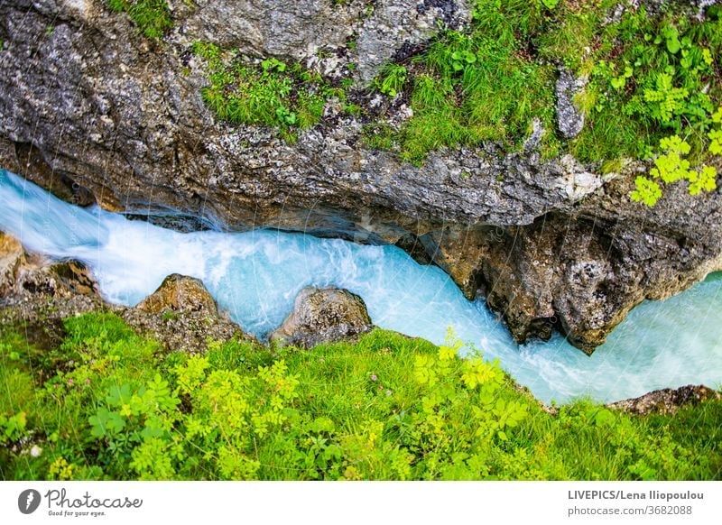 Mountain landscape with a blue stream and green vegatation copy space day daylight nature river shore sightseeing summer travel trip vegetation water