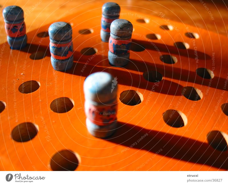 board game Leisure and hobbies Playing Board game Wood Light blue Orange Hollow Game rules Piece Figure solitaire Shadow Round Colour photo Close-up Deserted