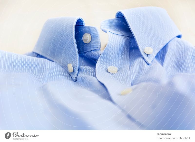 A light blue shirt with a button down collar. cotton dress fashion man clothing clothes business textile clean closeup nobody style white background garment