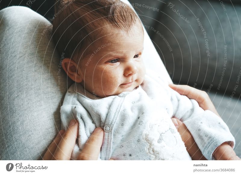 Upset newborn baby in pajama at home angry upset huff tantrum signal discomfort girl boy kid daughter son face expressive expression growth upbringing nurture